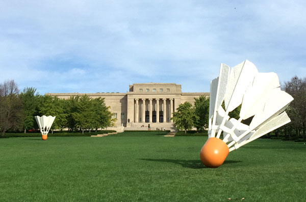 The Nelson Atkins Museum sculpture garden. Pictured are the museum building, shuttlecocks sculptures and expansive green lawn. 