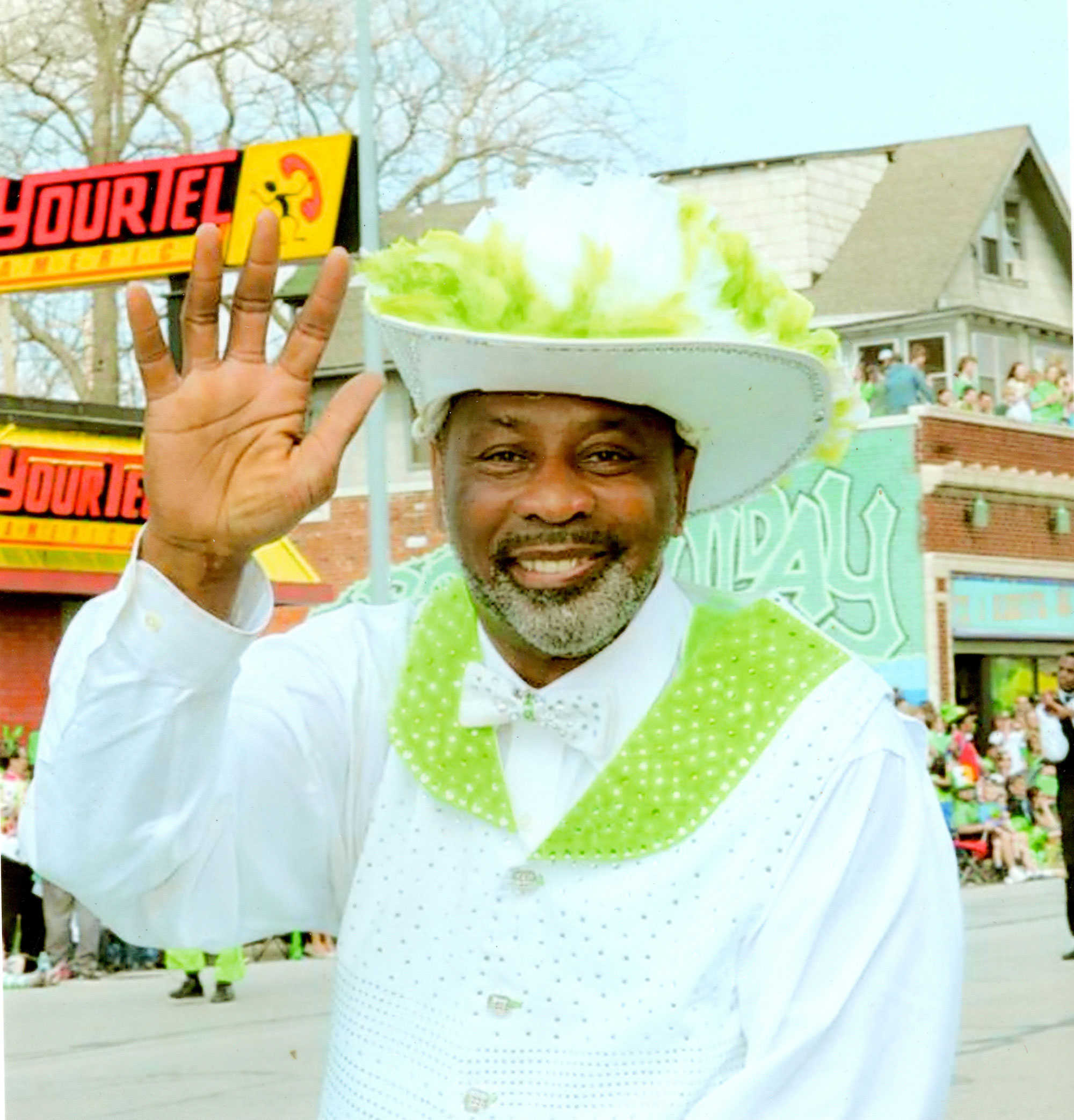 Close up photo of a smiling Willie Smith as he leads the Marching Cobras in a parade